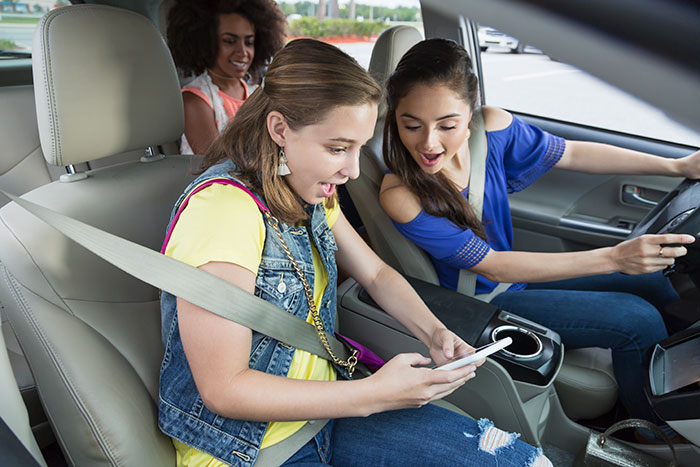 teenage girls in car laughing using mobile phone 920488578 5760x3840 teenage girls in car laughing using mobile phone 920488578 5760x3840